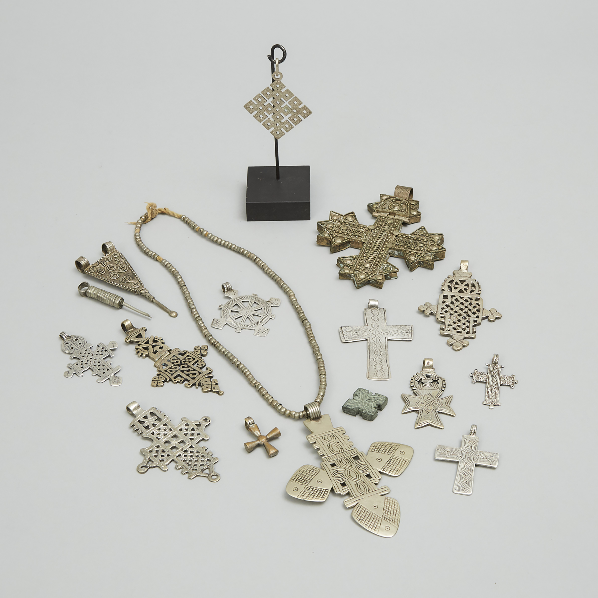 Fifteen Abyssinian/Ethiopian Silver and Silvered Brass Mostly Coptic Pendant Crosses, early-mid 20th century