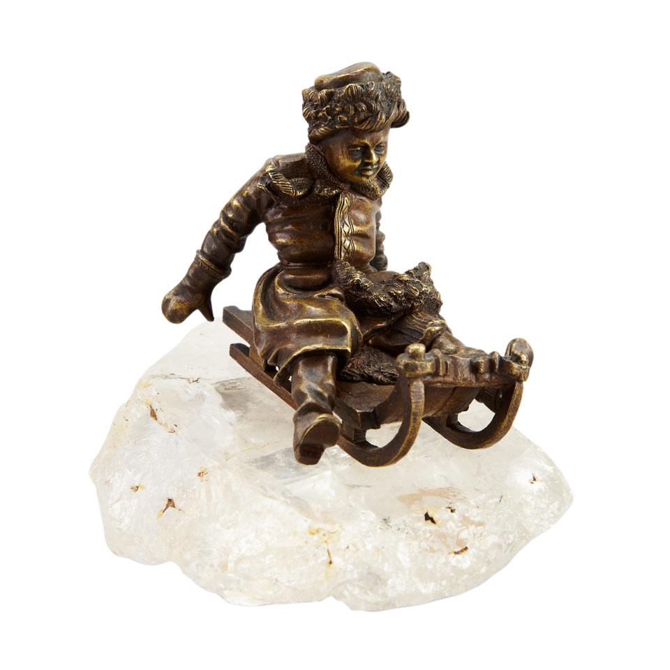 Russian School Gilt Bronze Figure of a Young Boy on a Sled, 19th/20th century
